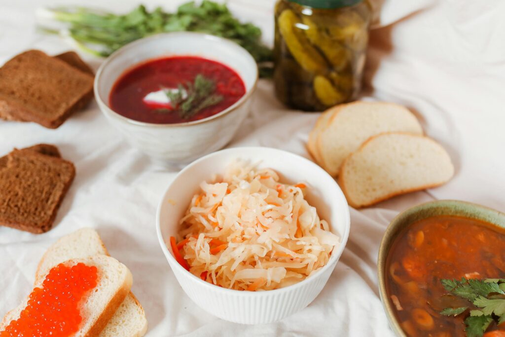 Close-up of freshly fermented sauerkraut, showcasing finely shredded cabbage with a slightly translucent texture, rich in probiotics for gut health. Vegan probiotics.