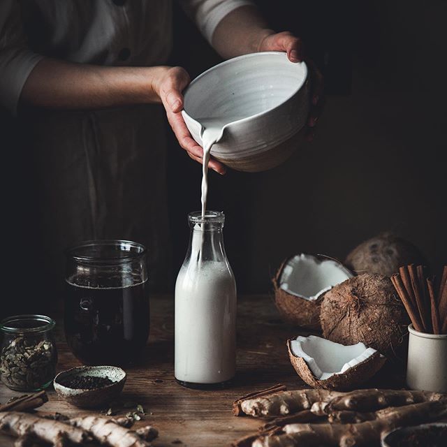 Assorted plant-based milks in glass bottles—coconut, almond, soy, and oat—ideal dairy-free alternatives for blood sugar and insulin balance in a diabetes diet.