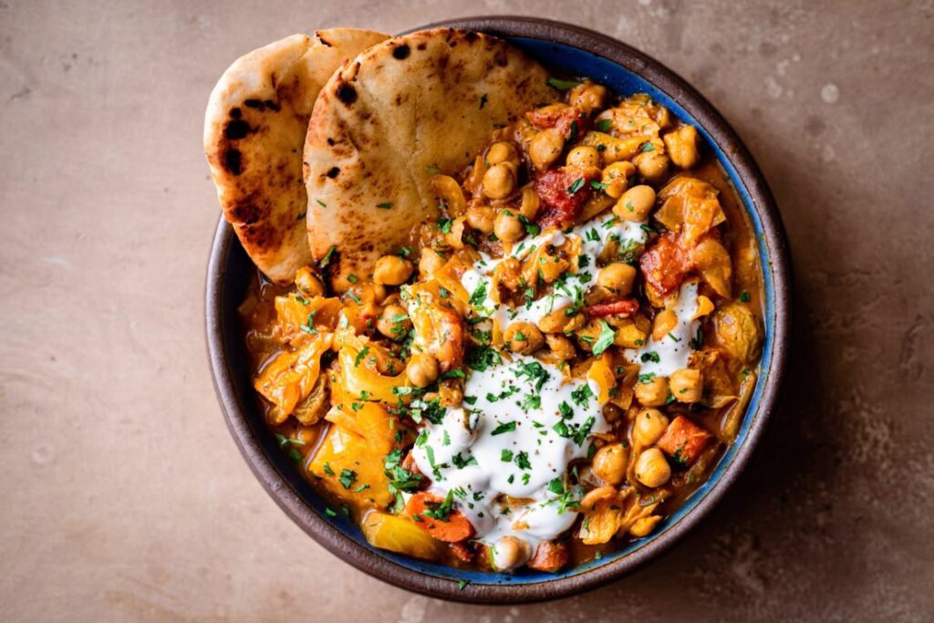 Weekly vegan meal planner surrounded by Indian groceries like vegetables, lentils, and spices for diabetes management